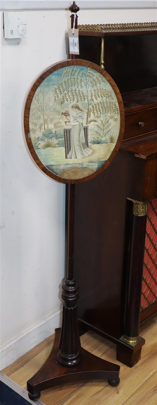 A Regency mahogany pole screen, with oval silkwork banner H.132cm